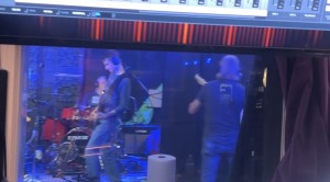 Gene performing live in the studio with their band, The Scene.