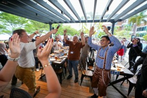 German dignitaries and media guests participating in the Fliegerlied dance