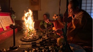 At Shōfuku-ji Temple, a priest performs a goma fire ritual, burning gomagi prayer tablets.