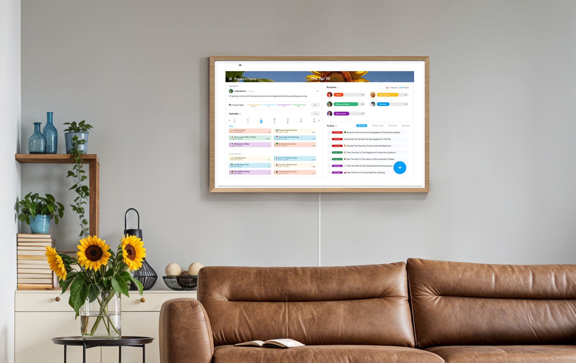 Apolosign digital calendar on a living room wall with colorcoded family schedules Apolosign digital calendar on a living room wall with colorcoded family schedules