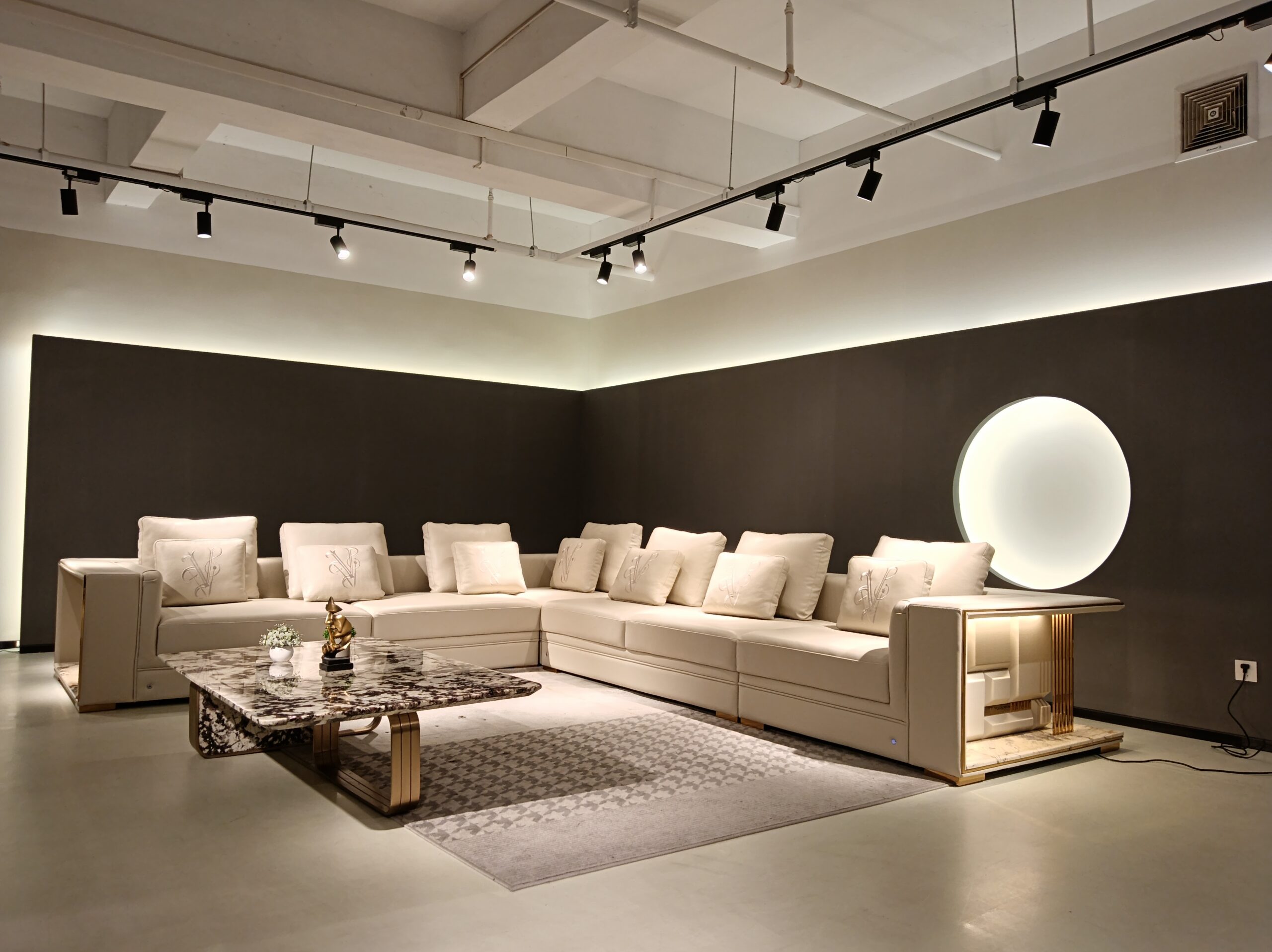 An upholstery swatch is compared with a sofa surface to check color and texture consistency
