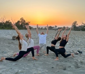 Yoga student practicing yoga asana at ganga beach