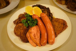 The Meatplatter consists of pork knuckles, pork schnitzel, mixed sausage, and roasted chicken