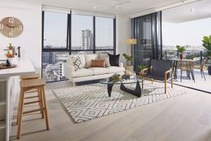 Spacious living rooms with city views at Omega Apartments