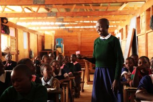 Girl explaining how to use Ruby Cup at the Golden Girls Foundation