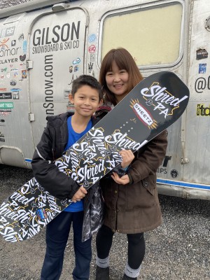 A winner receiving his new board at Gilson Headquarters