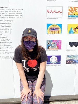 Isabella in front of plaza wall display