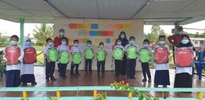 Students in SK Kampung Sawai in Daro receiving their new backpacks