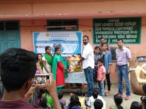 Kiran Handing over the Rice Bag