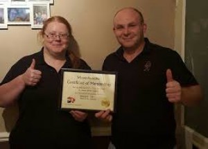 Removals Hull owners sam & Zoe proudly show off their move assured certificate