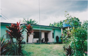 Iquo B Essien poses with a picture of her late grandmother near her former home in Calabar, Nigeria