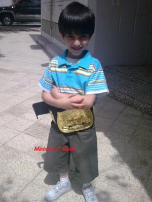 A young Aziz Wearing the world title belt