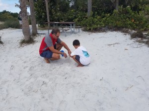 Owner Kevin Walters and his son collecting sand and water in Florida