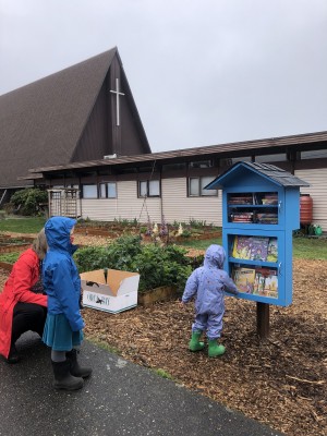 A child chooses a book from a Book Oasis at Luther Memorial Church.
