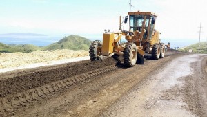 A grader prepares the road surface road treated by RSTs RT20