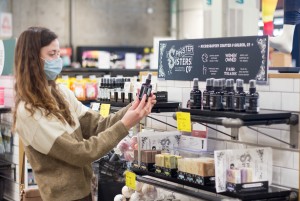Shopper at Spinster Sisters in-store display at Whole Foods Market