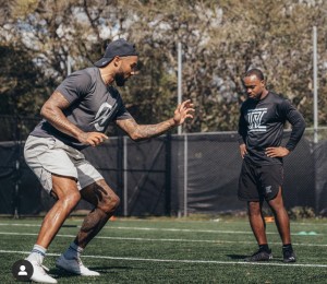 Former NFL Player Nolan Carroll coaching a young player.