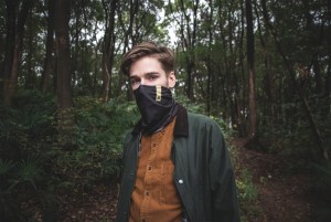 Male wearing scarf hiking in the woods