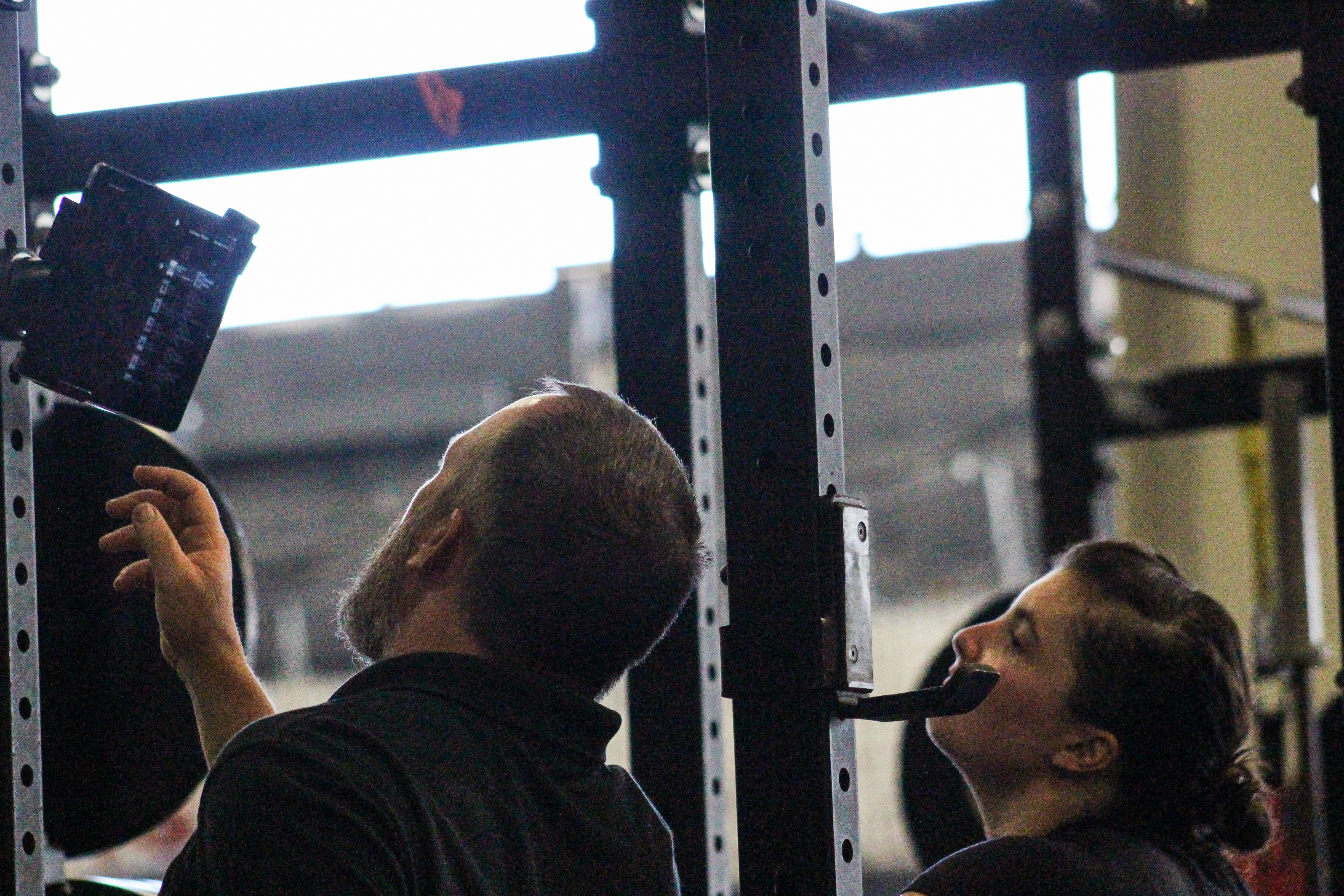 Track cyclist Maddie Godby looks at training data with Coach Vick