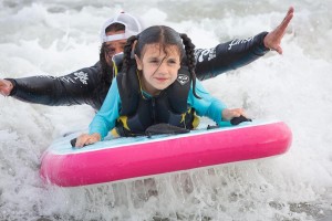 Catching waves is fun when you have a friend along