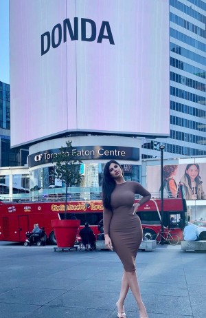 Dora Rodriguez in front of Donda Billboard at Dundas Square