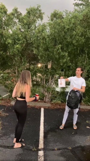 Nicholas Pinto giving girl brand new Beats headphones