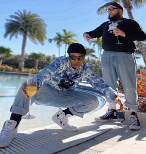Phresh Kidd Ice & Shaun Peezy poses by the pool.