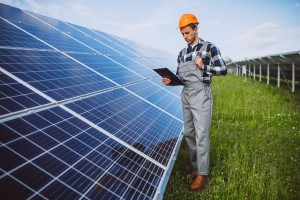 man worker firld by solar panels