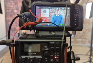 Co-Founder Jason Bland seen through a monitor in the CLM Studio.