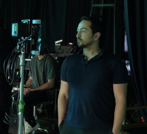 Director ZANE behind the scenes in a studio shooting a commercial