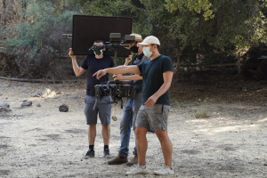 Director ZANE on set directing a fight scene for a music video
