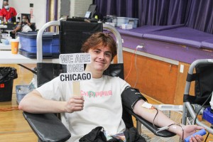 We Are One Youth Volunteer poses at earlier blood drive done in July