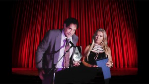 Steve Sayre receives the Best Documentary Film Award for 2022 from Lori Morrissey at TZIFF