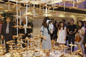 A visitor experiencing the Autumn VR landscape engaging her senses.