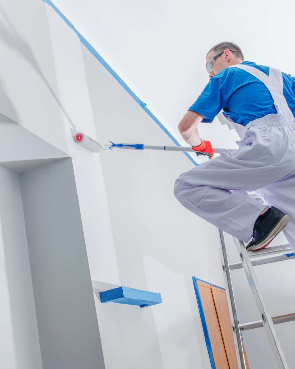 Careers Page Sign, Billboard, and Display Background Image A Sign, Billboard, and Display worker installs a sign in a hallway