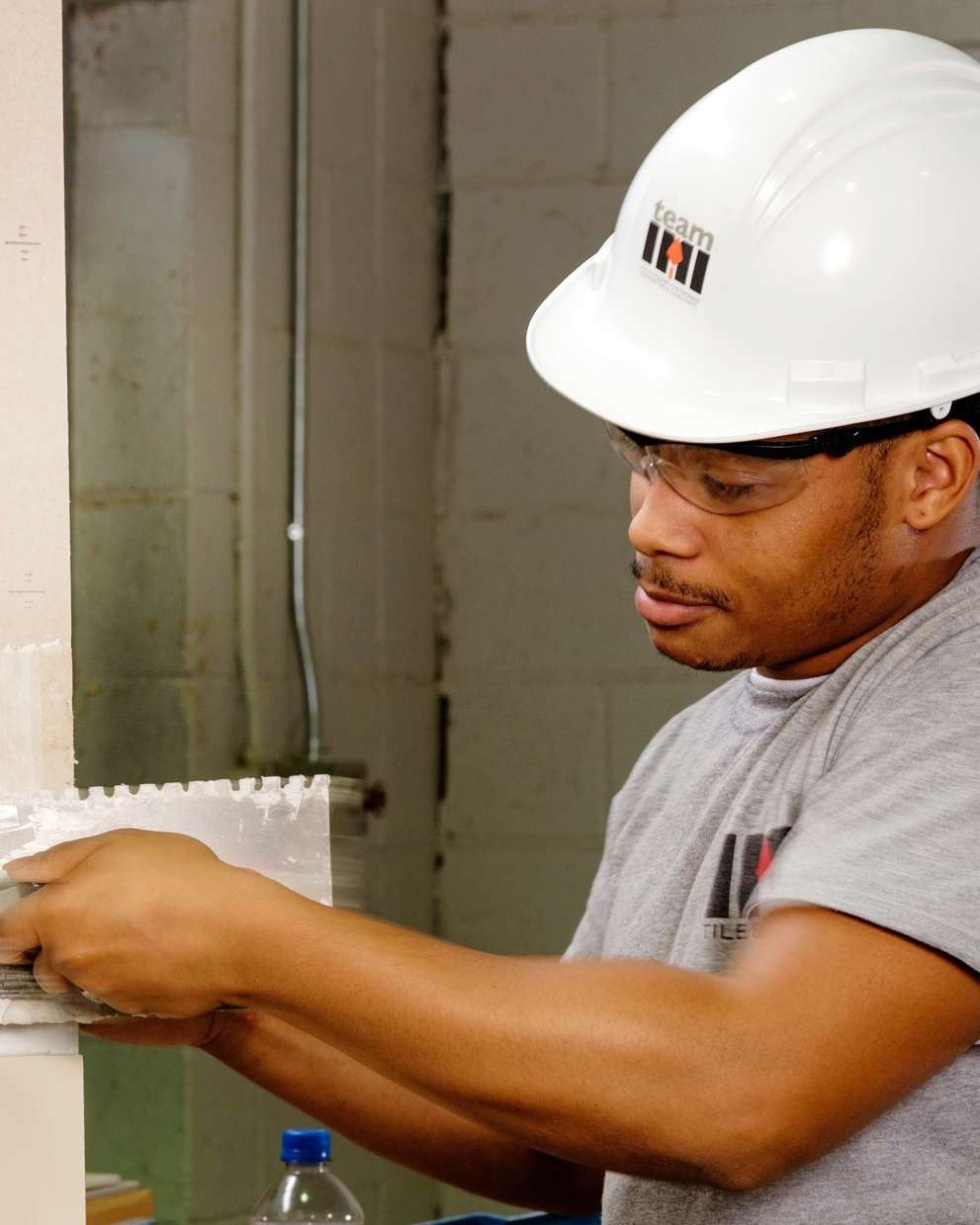 Careers Page Sign, Billboard, and Display Background Image A Sign, Billboard, and Display worker installs a sign in a hallway