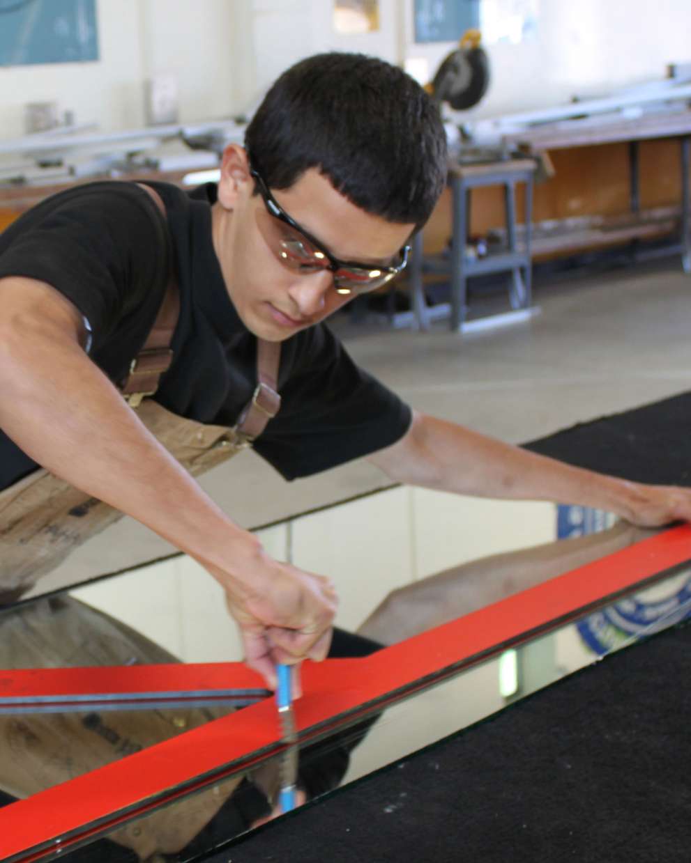 Careers Page Sign, Billboard, and Display Background Image A Sign, Billboard, and Display worker installs a sign in a hallway