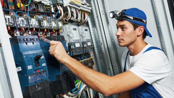 Careers Page Sign, Billboard, and Display Background Image A Sign, Billboard, and Display worker installs a sign in a hallway