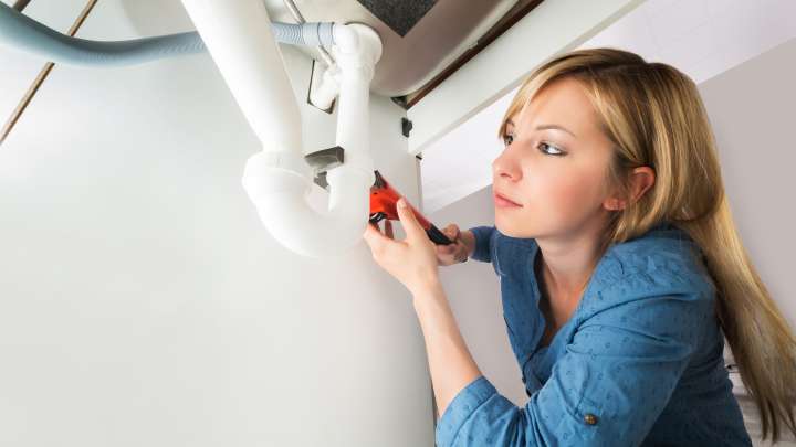 Careers Page Sign, Billboard, and Display Background Image A Sign, Billboard, and Display worker installs a sign in a hallway