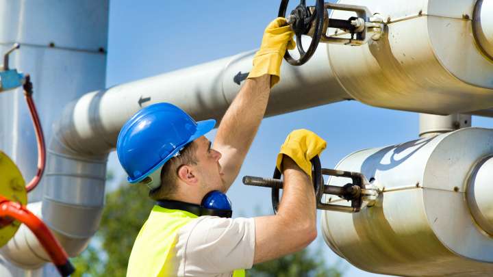 Careers Page Sign, Billboard, and Display Background Image A Sign, Billboard, and Display worker installs a sign in a hallway