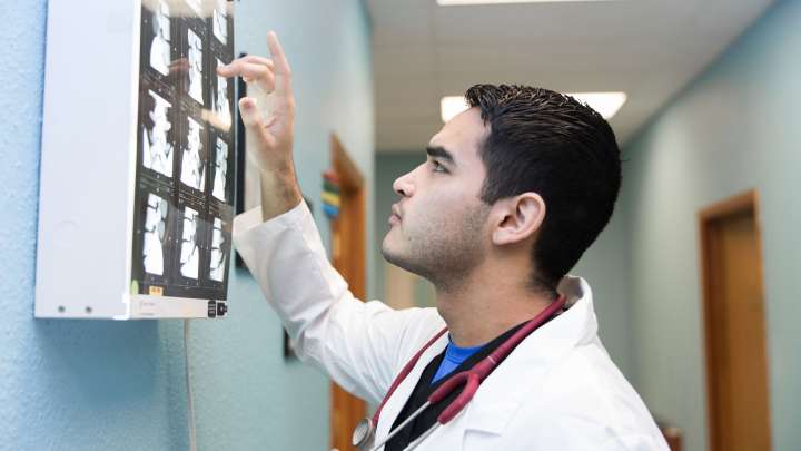 Careers Page Sign, Billboard, and Display Background Image A Sign, Billboard, and Display worker installs a sign in a hallway