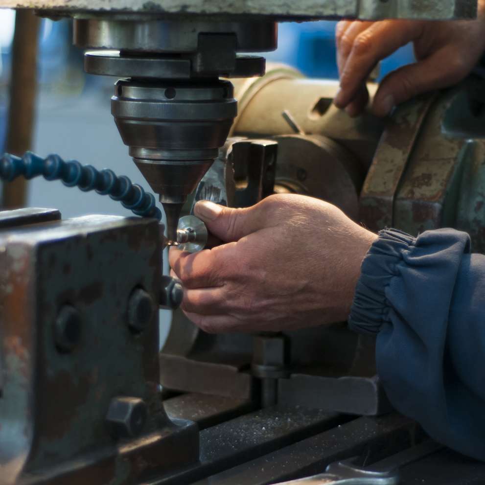 Careers Page Advanced Machinist Background Image A machinist at work behind a specialized tool.