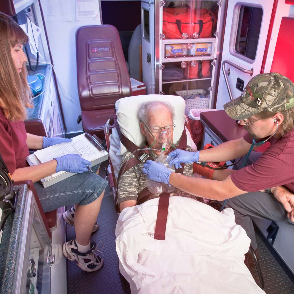 Careers Page Emergency Medical Technician Image An Emergency Medical Technician cares for a patient in an ambulance.