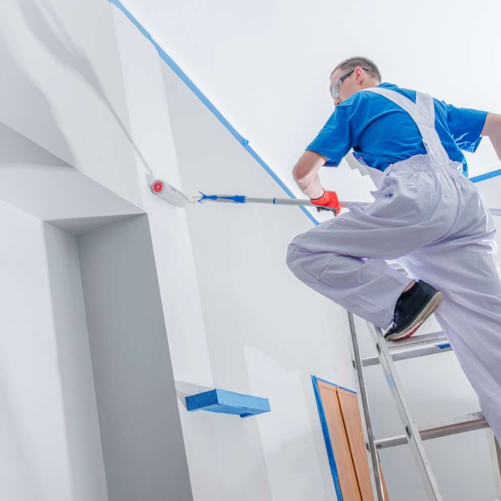 Careers Page Sign, Billboard, and Display Background Image A Sign, Billboard, and Display worker installs a sign in a hallway