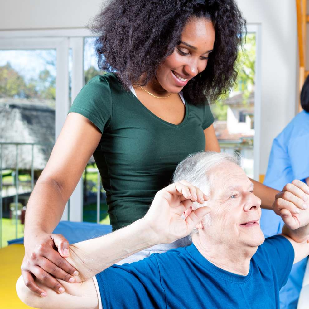 A Rehabilitation Technician helps restore an elderly patient's flexibility and strength