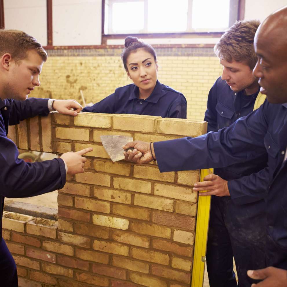 Careers Page Sign, Billboard, and Display Background Image A Sign, Billboard, and Display worker installs a sign in a hallway