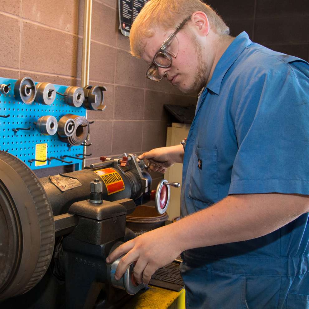Advanced Auto Diesel/ Collision career image Job Corps student working with auto parts