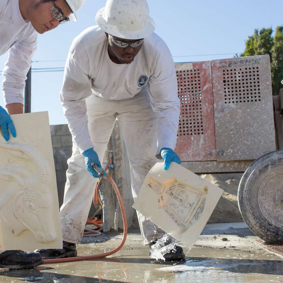 Job Corps students cleaning cement molds