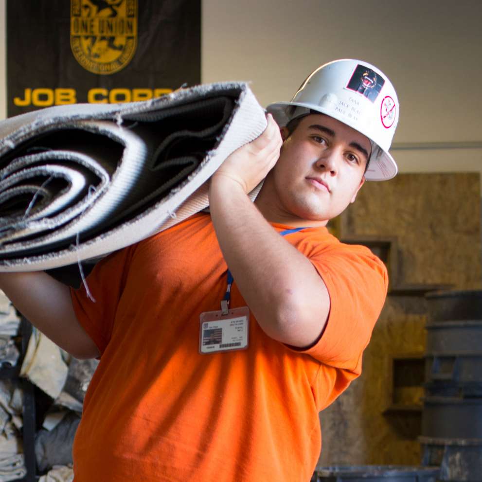 Floor covering career image Floor covering student hauling old carpeting