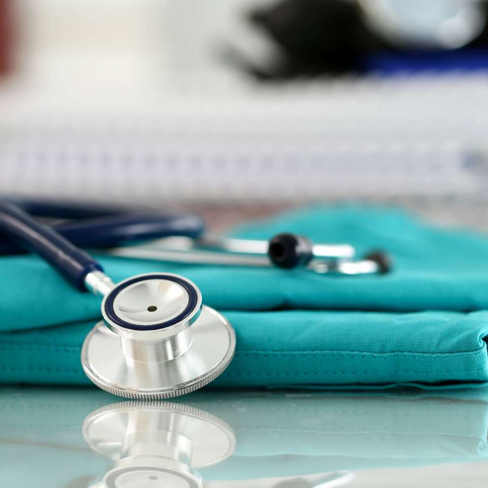 Student Story hero image Stethoscope sitting on folder scrubs